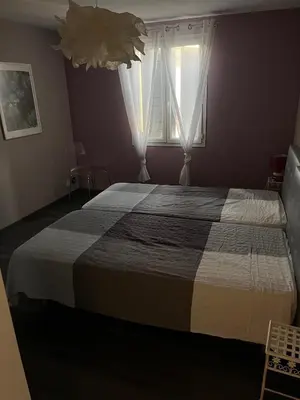 a bedroom with a large bed with a window at Mas Rémy-Villa in private residence in Saint-Rémy-de-Provence