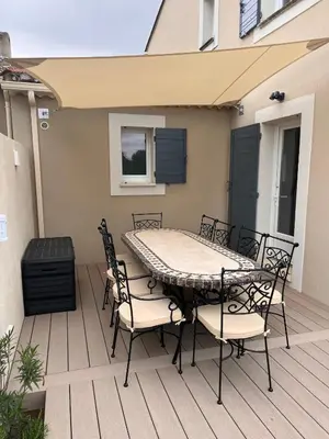 a patio with a table and chairs on a deck at Mas Rémy-Villa in private residence in Saint-Rémy-de-Provence
