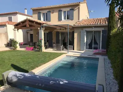 a house with a swimming pool in front of a house at Mas Rémy-Villa in private residence in Saint-Rémy-de-Provence