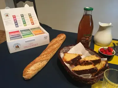 a table with a basket of bread and a bottle of ketchup at l'Estagnol in Ansouis