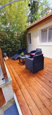 a patio with two couches on a wooden deck at La Chambrette in Salon-de-Provence