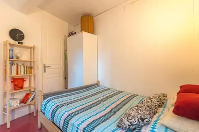 a bedroom with a bed and a book shelf at Finsonius Studios in Aix-en-Provence