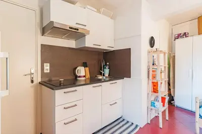 a kitchen with white cabinets and a sink at Finsonius Studios in Aix-en-Provence