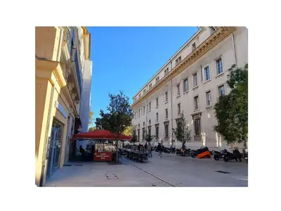 a city street with a building and a red umbrella at Finsonius Studios in Aix-en-Provence