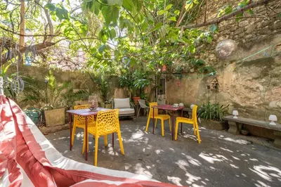 a group of tables and chairs in a garden at Finsonius Studios in Aix-en-Provence