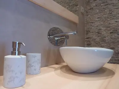 a bathroom with a white bowl sink and a faucet at Les Mazets du Luberon in Puget