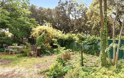 a garden with a table and chairs and trees at Lovely Home In Carpentras With Wifi in Carpentras