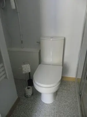 a bathroom with a white toilet in a room at GitesLuberon 1 studio in Charleval