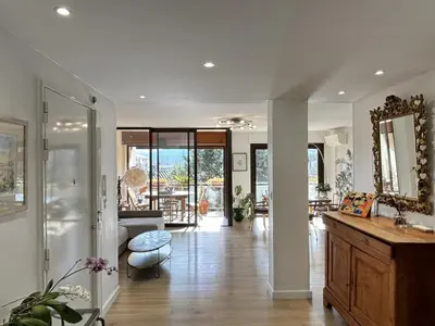 a living room with a sink and a mirror at Les Cerisiers in Aix-en-Provence