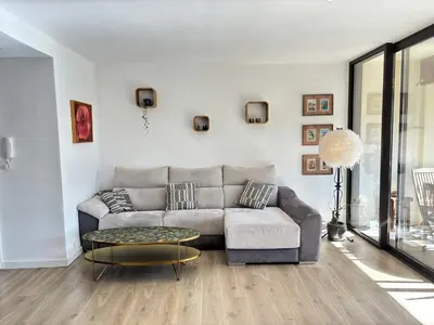 a living room with a couch and a table at Les Cerisiers in Aix-en-Provence