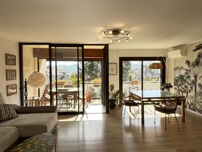 a living room with a couch and a table at Les Cerisiers in Aix-en-Provence