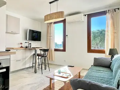 a living room with a couch and a table at Lou Miradou 1 - Vieux village médiéval, Cosy, Clim, 2 personnes in Miramas