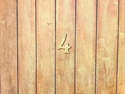 a wooden door with a plus sign on it at Lou Miradou 1 - Vieux village médiéval, Cosy, Clim, 2 personnes in Miramas