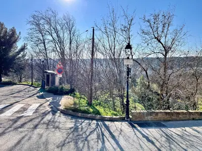 an empty road with a bus stop and a street light at Lou Miradou 1 - Vieux village médiéval, Cosy, Clim, 2 personnes in Miramas