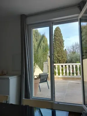 a sliding glass door looking out onto a patio at Appartement indépendant dans une villa in Miramas