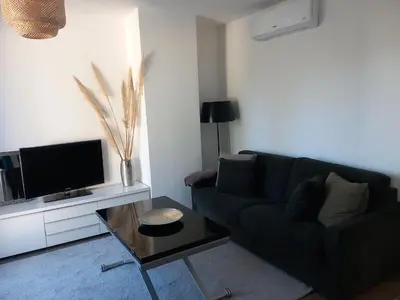 a living room with a couch and a coffee table at Appartement indépendant dans une villa in Miramas