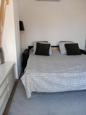 a bedroom with a bed with two pillows on it at Appartement indépendant dans une villa in Miramas