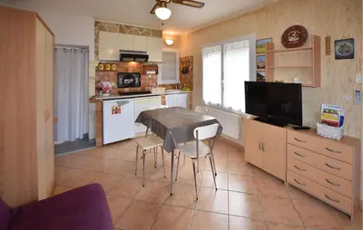 a kitchen with a table and chairs in a room at Frutiere 1 in Caromb