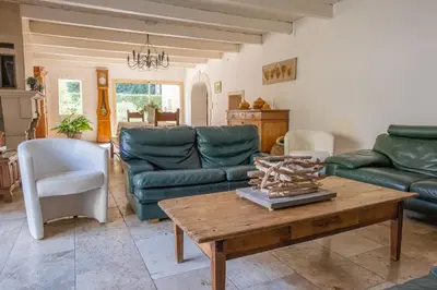 a living room with green couches and a coffee table at Mas des Agranas in Sénas