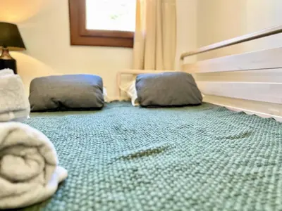 a bedroom with two pillows on the floor at Lou Miradou 2 - Vieux village médiéval, Cosy, Clim, 2 personnes in Miramas