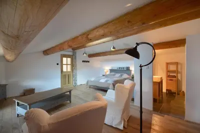 a bedroom with a bed and a table and chairs at Le domaine de Villemus chambre d'hote in Jouques