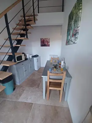 a kitchen with a table and stairs in a room at Le domaine de Villemus chambre d'hote in Jouques