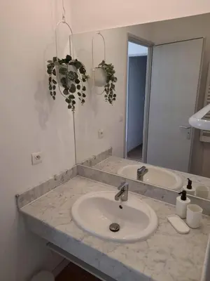 a bathroom counter with a sink and a mirror at Le Mazet des Jasmins in Gordes
