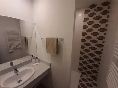 a white bathroom with a sink and a mirror at Le Mazet des Jasmins in Gordes