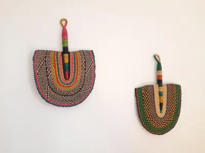 a pair of crochet purses hanging on a wall at Le Mazet des Jasmins in Gordes
