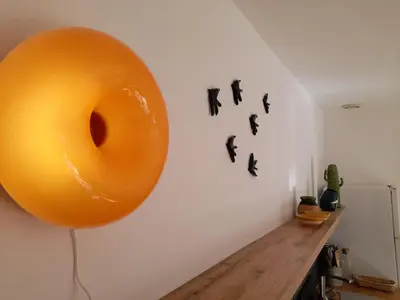 a large orange balloon hanging on a wall at Le Mazet des Jasmins in Gordes