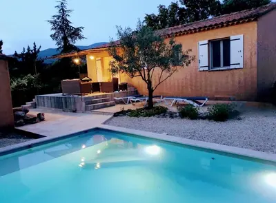 a swimming pool in front of a house at Chez Mylène et Jean in Bédoin