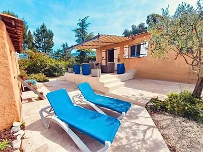 a couple of blue lounge chairs on a patio at Chez Mylène et Jean in Bédoin
