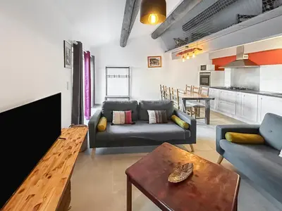 a living room with a couch and a table at Maison provençale de charme au cœur du Luberon in Saint-Saturnin-les-Apt