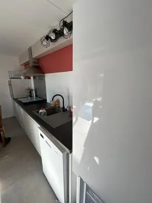 a kitchen with a sink and a white refrigerator at Maison provençale de charme au cœur du Luberon in Saint-Saturnin-les-Apt