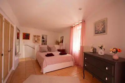 a bedroom with a bed and a dresser in it at Maison Valabregue in Robion en Luberon