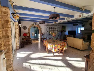a living room with a table and a couch at Mas Provençal with Swimming Pool & Air Conditioning in Rustrel