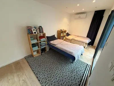 a bedroom with two beds and a book shelf at Maisonnette in Aix-en-Provence