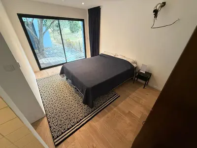 a bedroom with a bed and a large window at Maisonnette in Aix-en-Provence