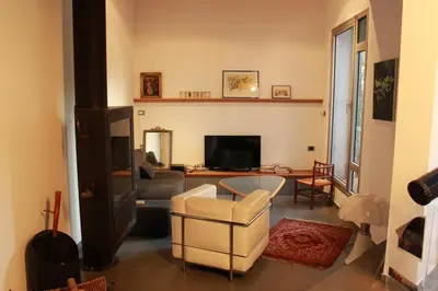 a living room with a couch and a television at Maison aix en Provence piscine in Aix-en-Provence