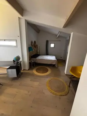 a bedroom with a bed and a room with a floor at Maison aix en Provence piscine in Aix-en-Provence