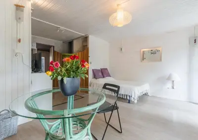 a room with a glass table with a vase of flowers on it at Espace Ki-Zen in Pélissanne