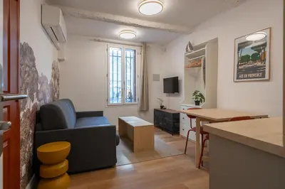 a white bathroom with a sink and a mirror at Studio Climatisé rdc plein centre in Aix-en-Provence