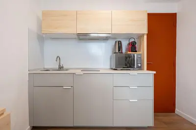 a small bedroom with a bed and a television at Studio Climatisé rdc plein centre in Aix-en-Provence
