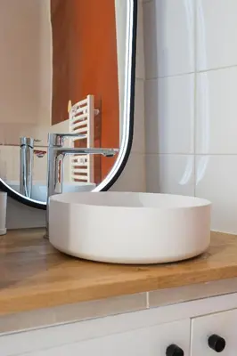 a bathroom with a white sink and a mirror at Studio climatisé plein centre ville 1er ETAGE in Aix-en-Provence