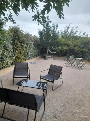 a group of chairs and a table in a yard at Gîte La Chouette Hulotte classé 3 étoiles Spa, Mt Ventoux, Parc Spirou in Flassan