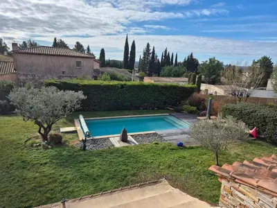 a backyard with a swimming pool in a yard at Villa 170m2 avec piscine près d Aix en provence 7 couchages in Éguilles