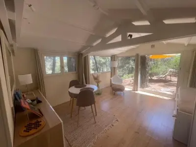 a living room with a table and a dining room at Le Charmeur - Le Chalet Attrape-Coeur in Aix-en-Provence