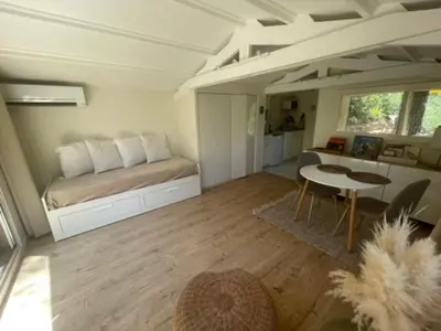 a bedroom with a bed and a table in it at Le Charmeur - Le Chalet Attrape-Coeur in Aix-en-Provence
