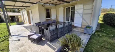 a patio with chairs and a table on a house at Charming villa with a pool in Cadenet