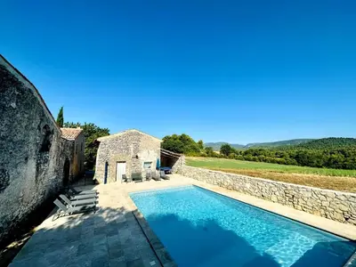 an external view of a swimming pool in a villa at Provencal farmhouse in Luberon's heart with pool in La Bastide-des-Jourdans